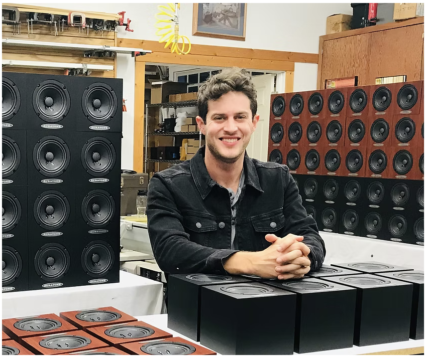 Alex Jacobsen surrounded by Auratone speakers in the workshop